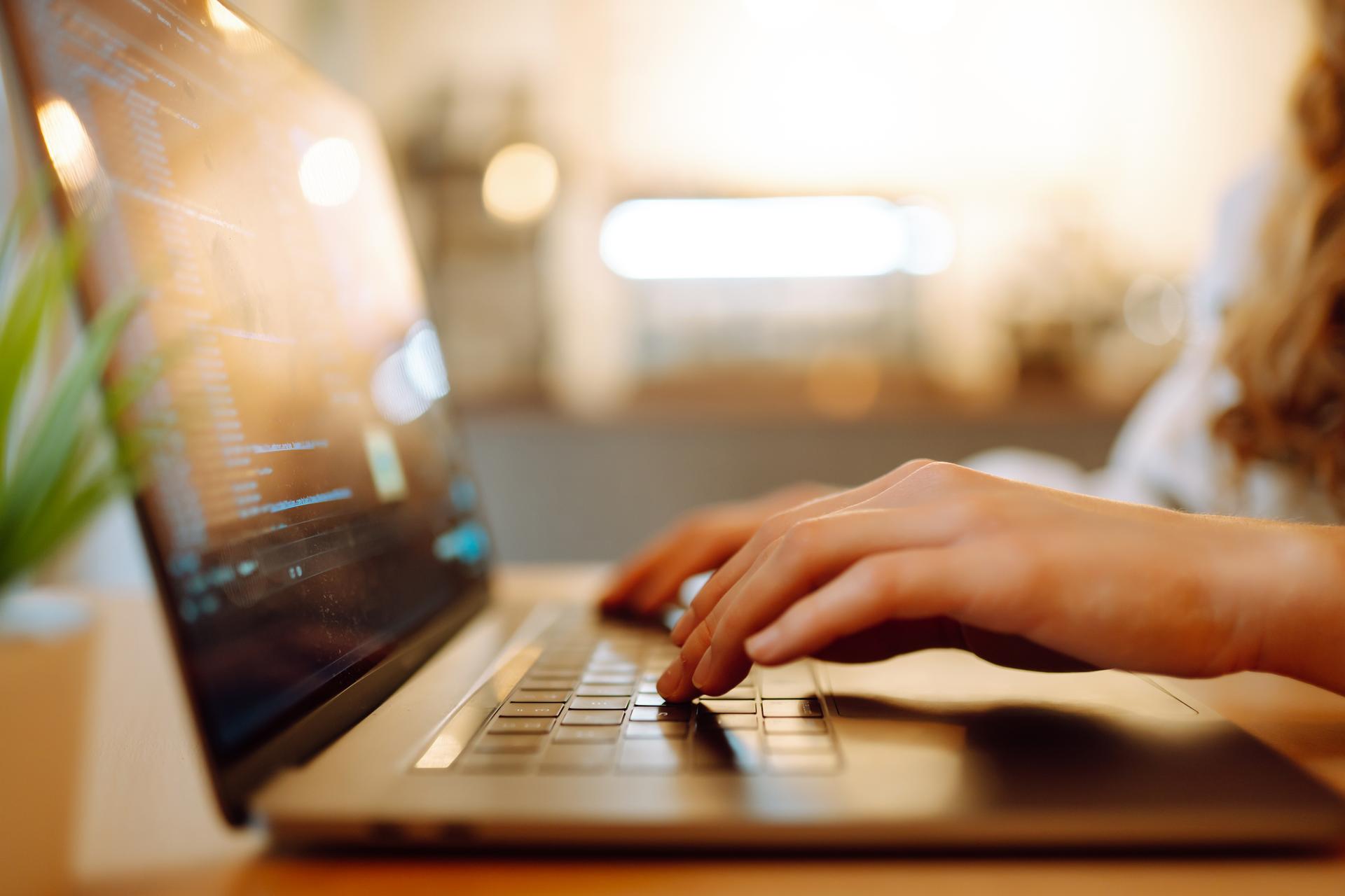 Female hands working on a laptop, close-up. Technology, Freelance, online course, remote work and lifestyle concept.